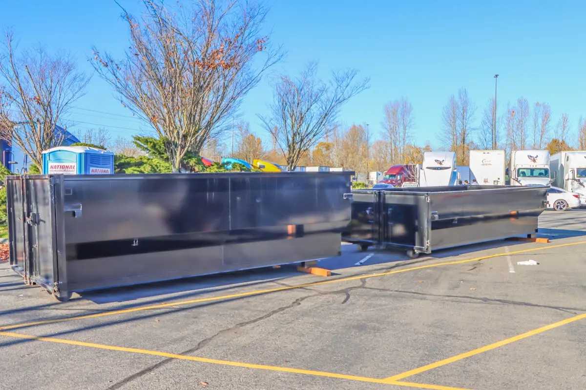 Professional dumpster rental service with roll-off container on residential driveway in Mims